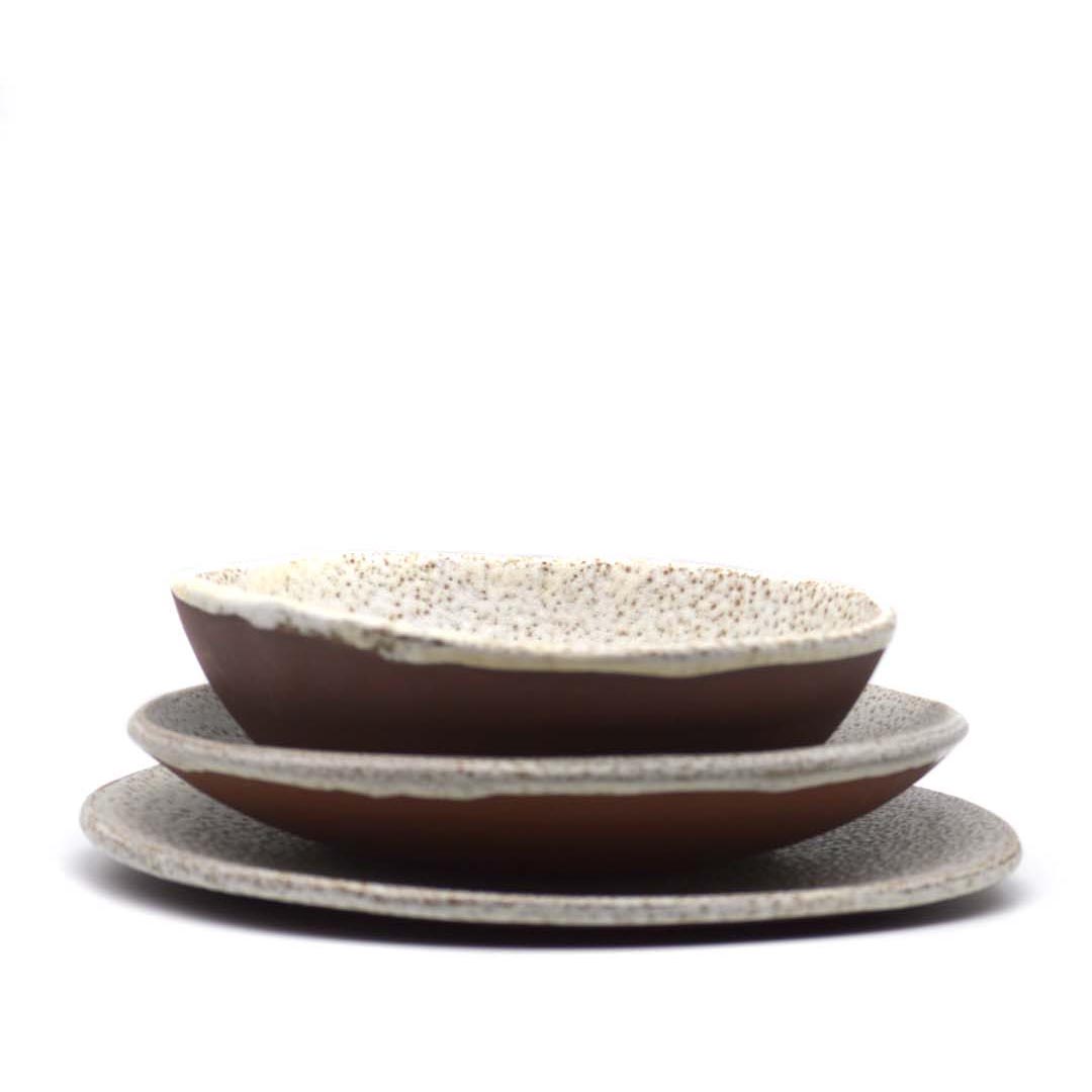 Buño clay plates with cream speckled glaze by O Falsete