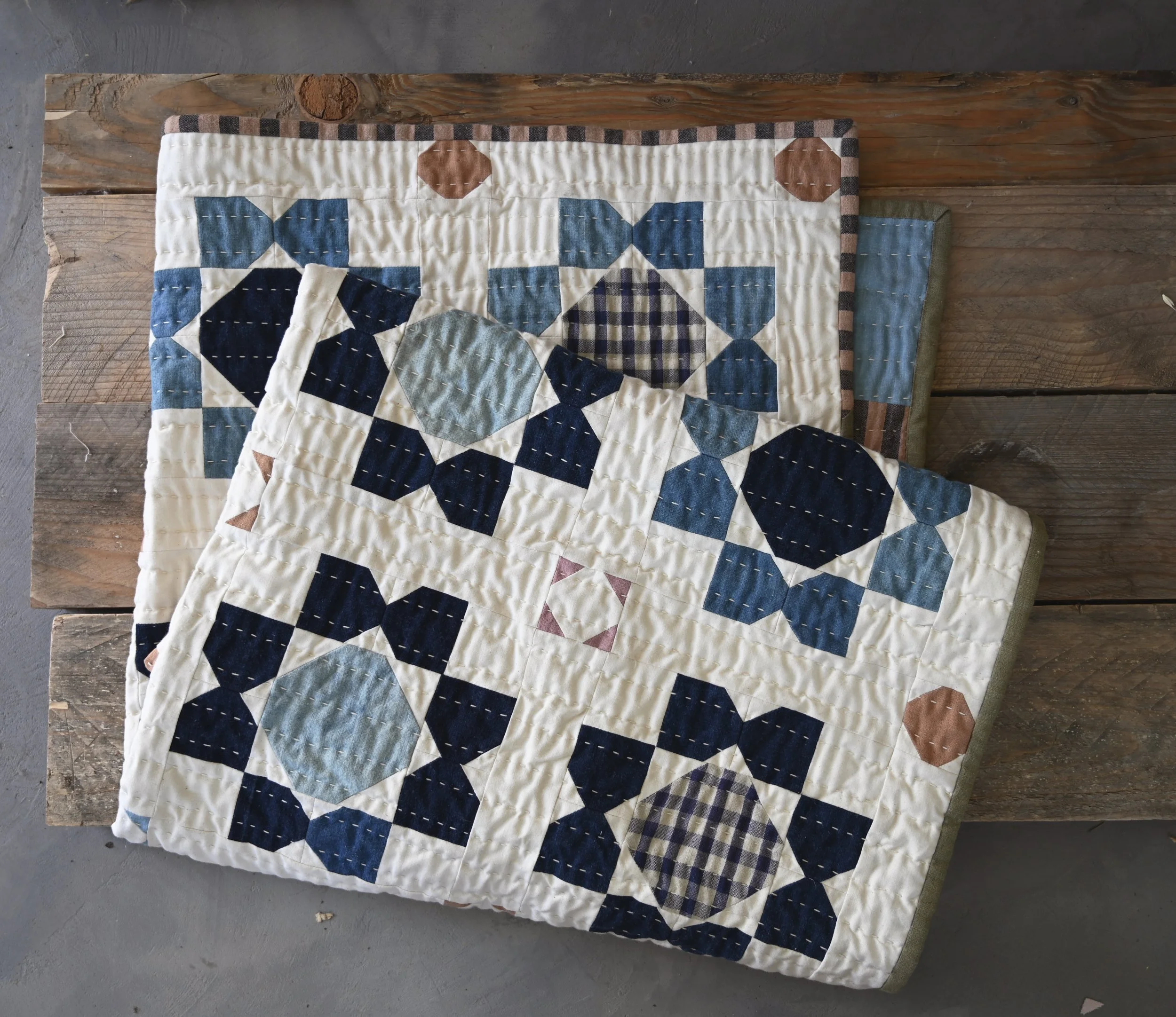Neutral Patchwork quilt on rustic wood