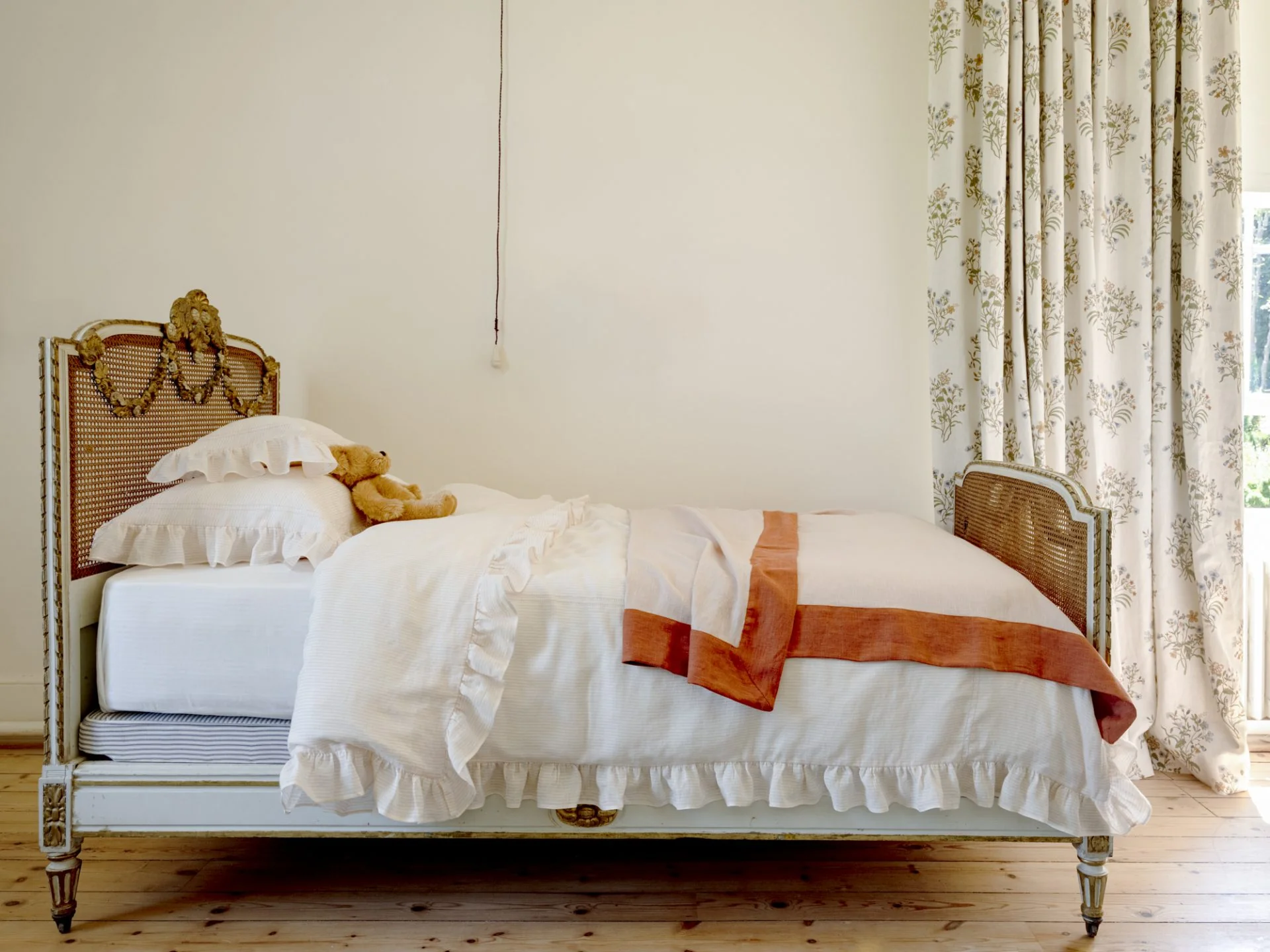 Linen bedding with thick rose and terracotta linen throw.