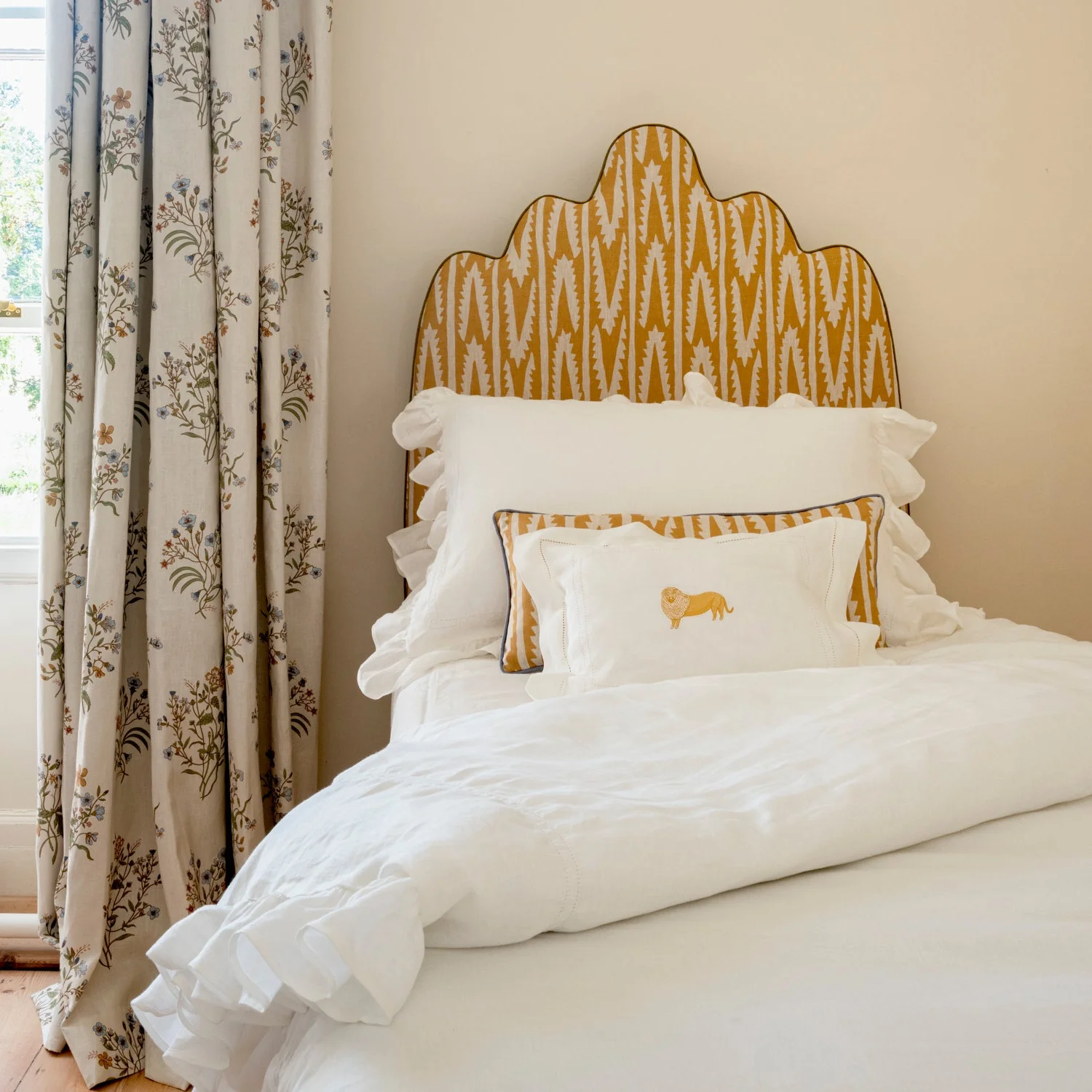 Patterned mustard yellow and white linen headboard.