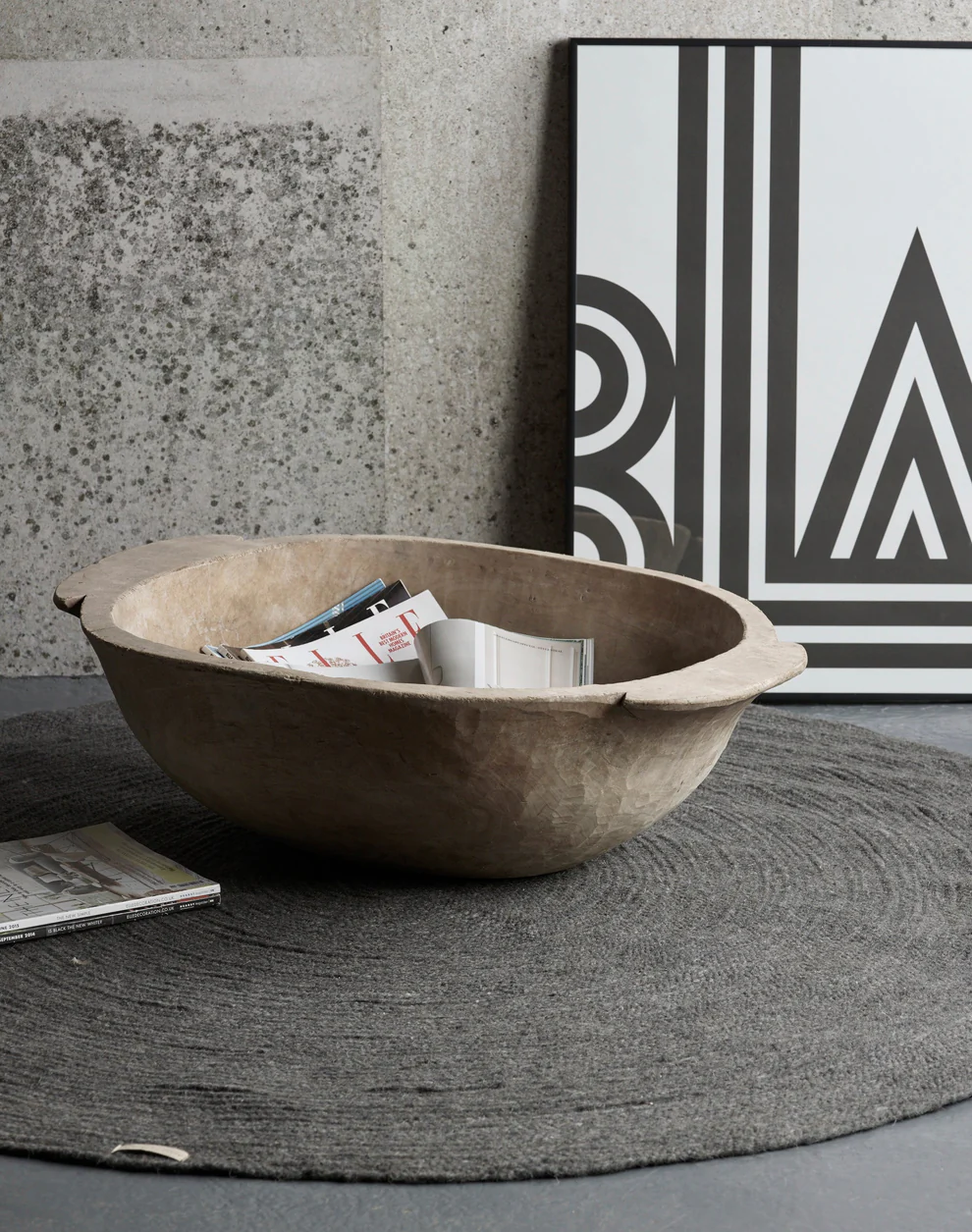 old vintage dough bowl repurposed as a magazine holder