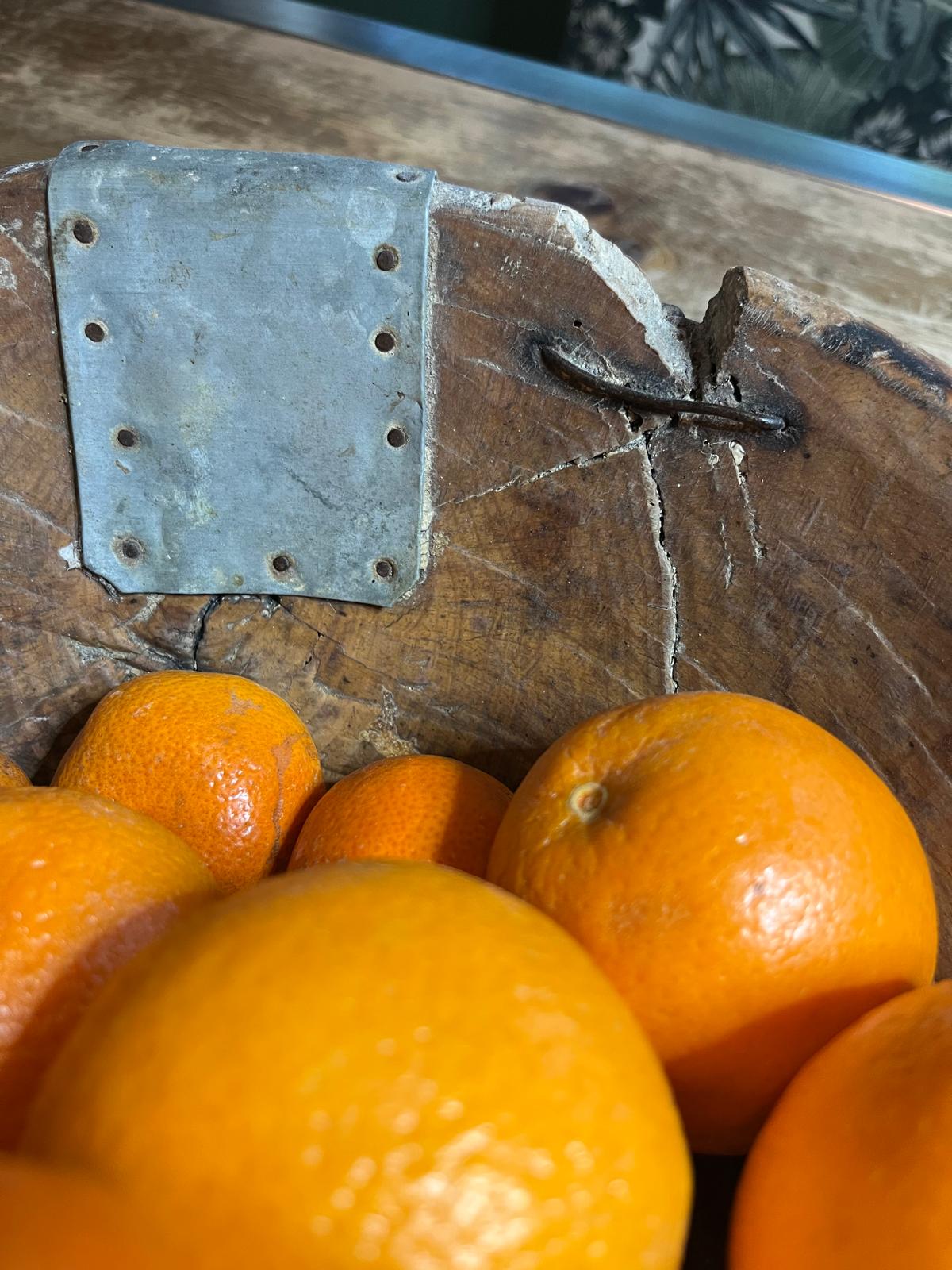 butterfly repair and metal patch repairs on old wooden dough bowl