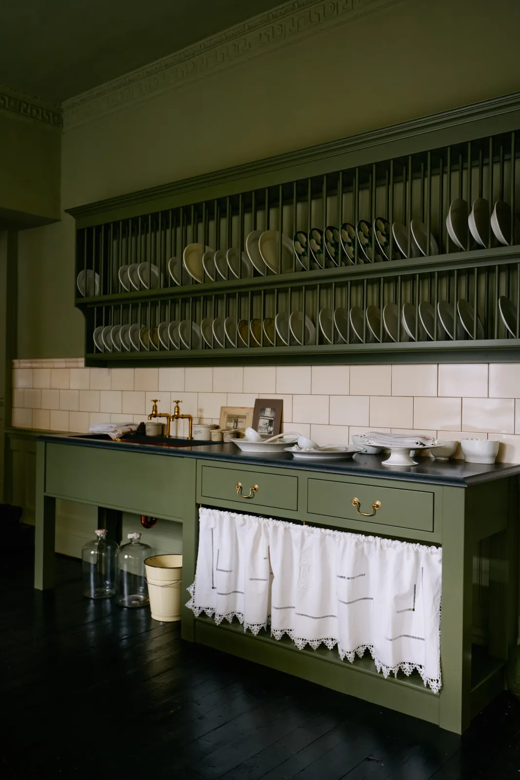 Green unfitted kitchen with visible plumbing